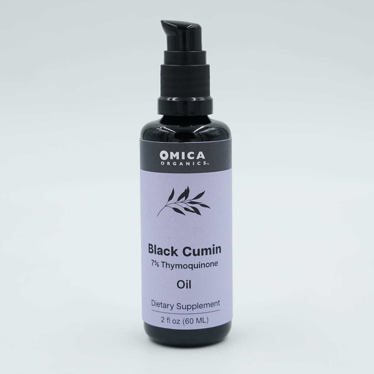 Bottle of Omica Organics Black Cumin Oil on a light gray background