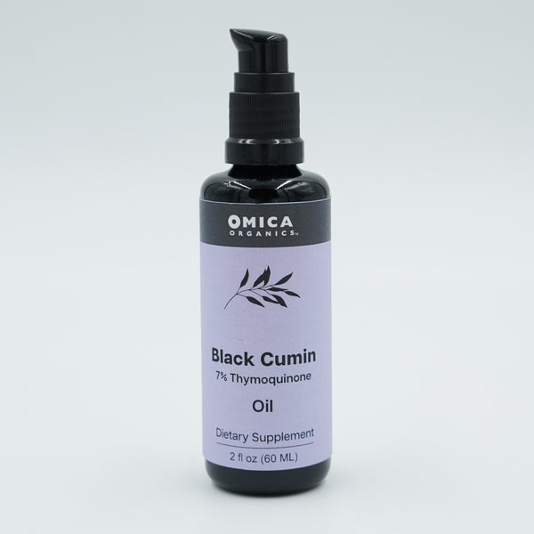 Bottle of Omica Organics Black Cumin Oil on a light gray background