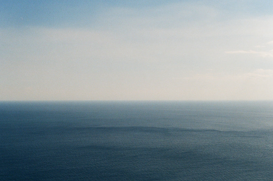 Horizon between ocean and sky with a gradient of blue and gray. Pure Organic Ingredients.