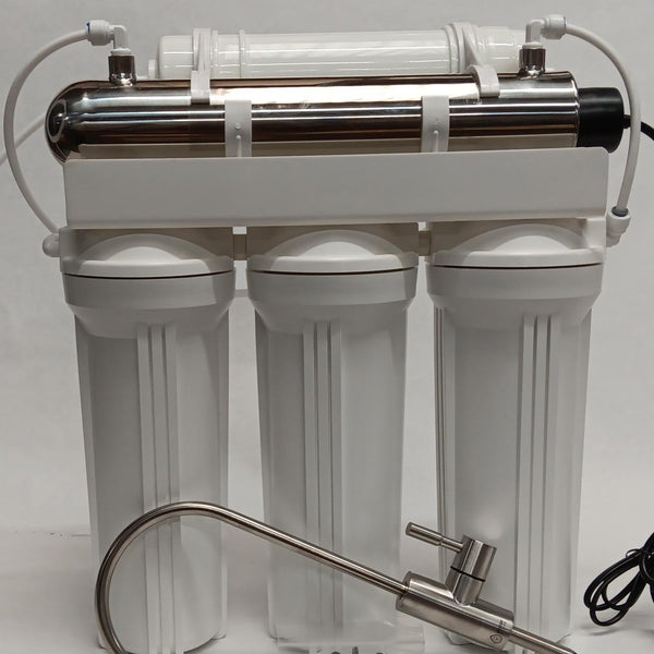 Water filtration system with three cylindrical tanks and a faucet on a white background