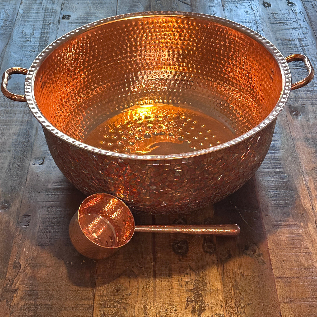 Omica Mosaic Copper Foot with Copper Ladle on a wooden surface